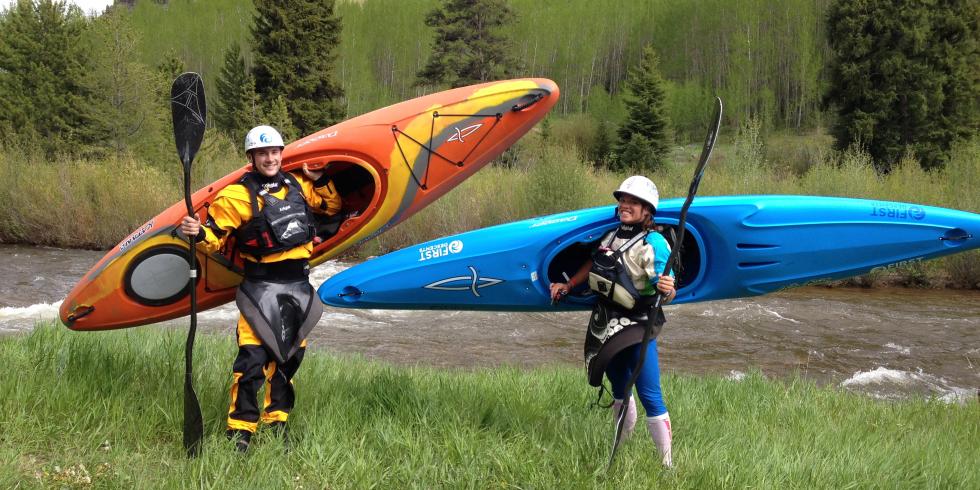 Two Kayakers holding their gear